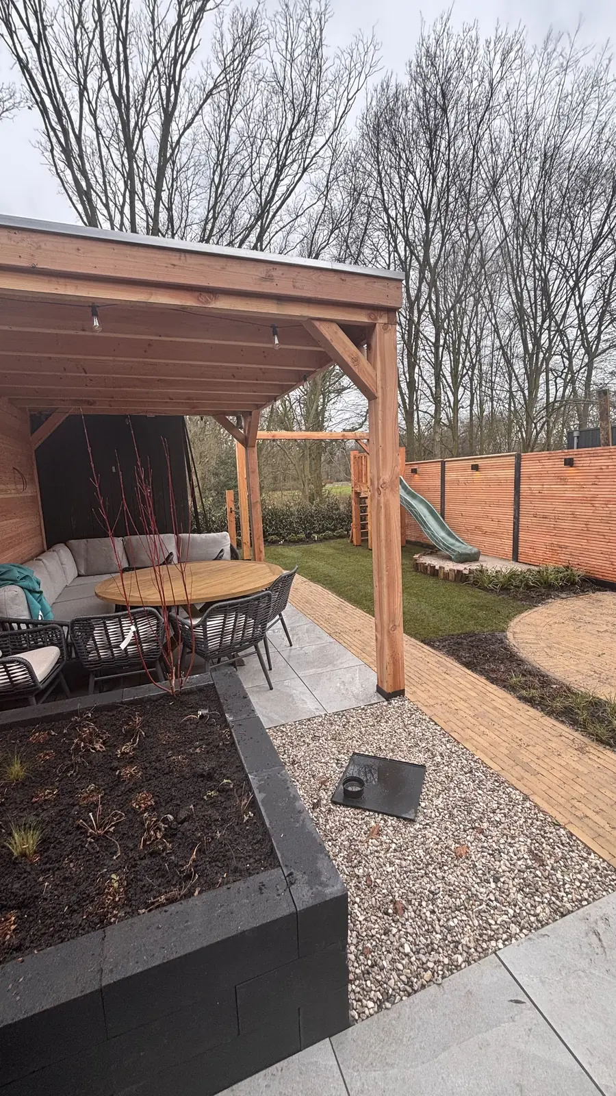 Zicht op de overkapping over de verhoogde plantenbak heen